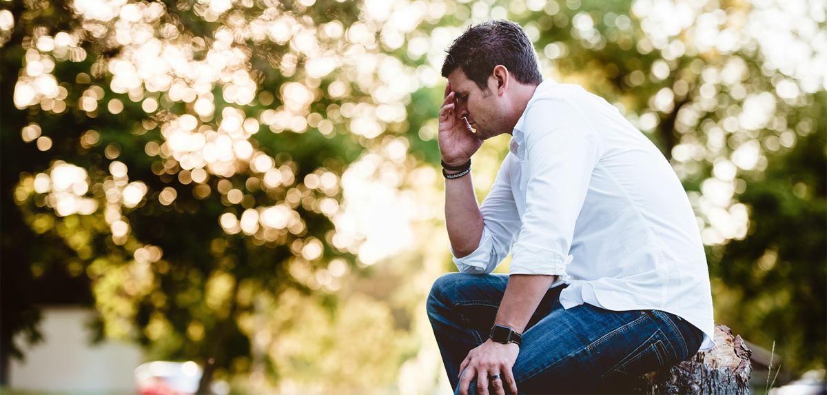  man holding his head looking worried